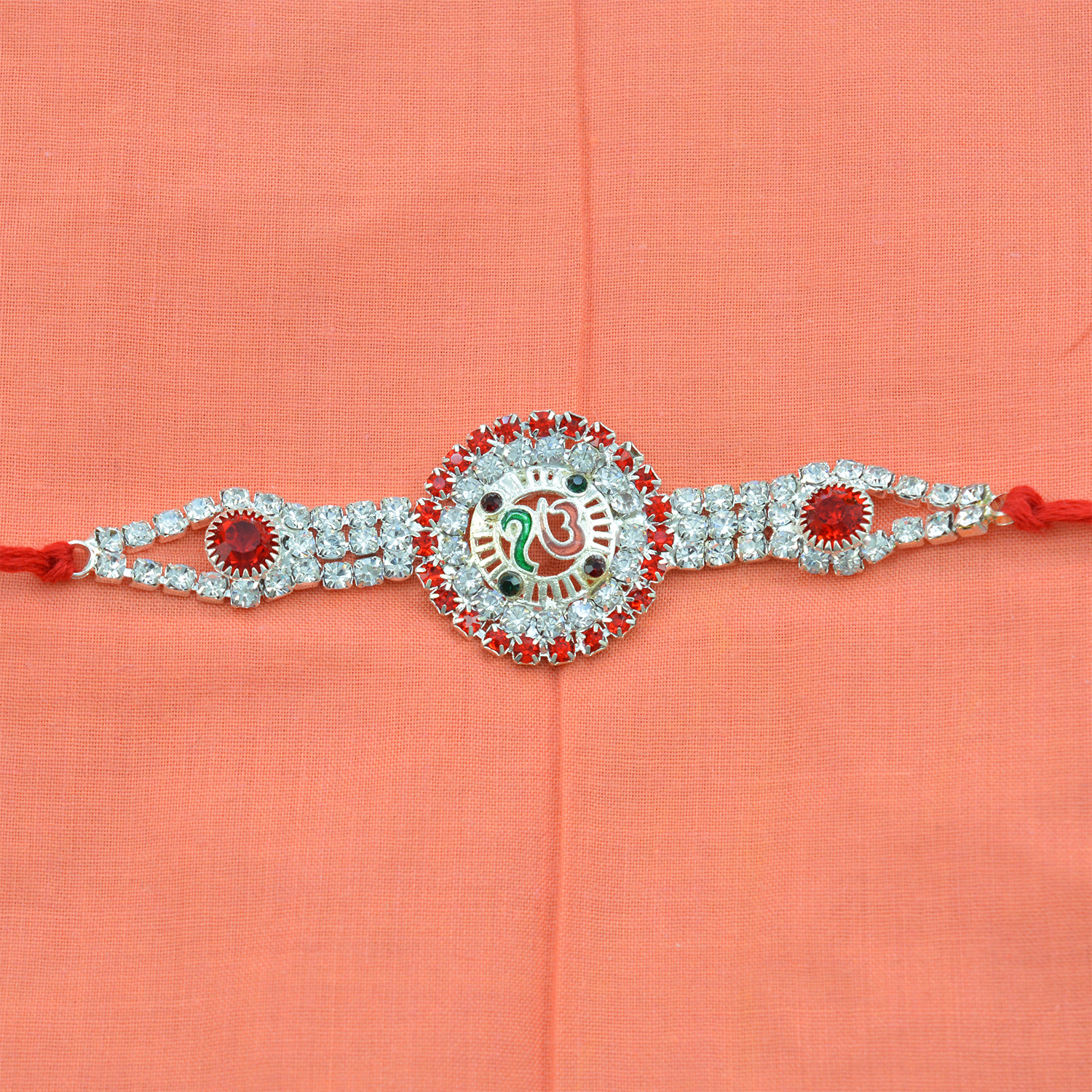 Silver Designed Onkar Rakhi with Red and White Diamonds