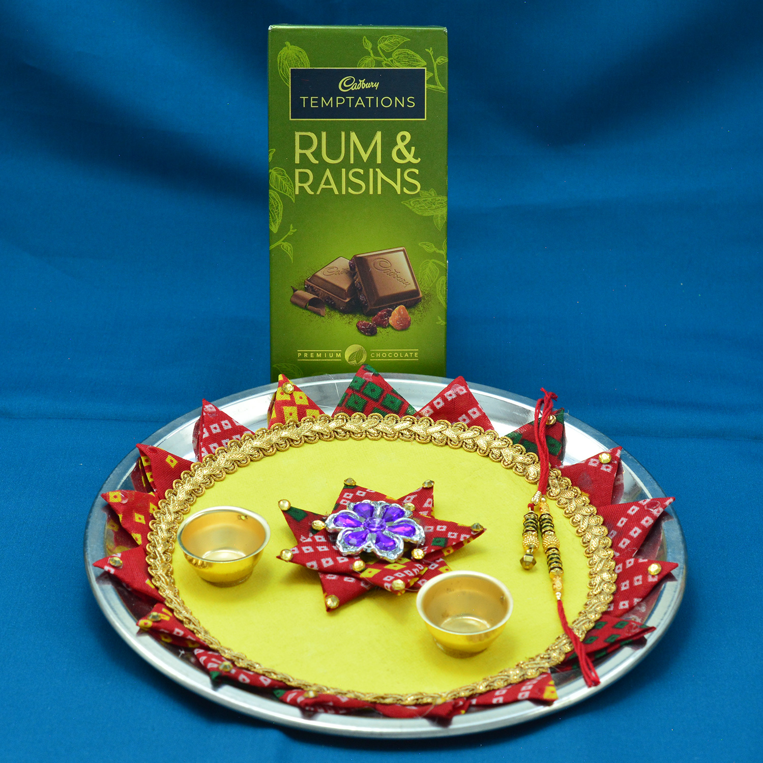 Temptation Rum Raisins Chocolates Hamper with Amazing Triangle Designer Pooja Thali for Raksha Bandhan