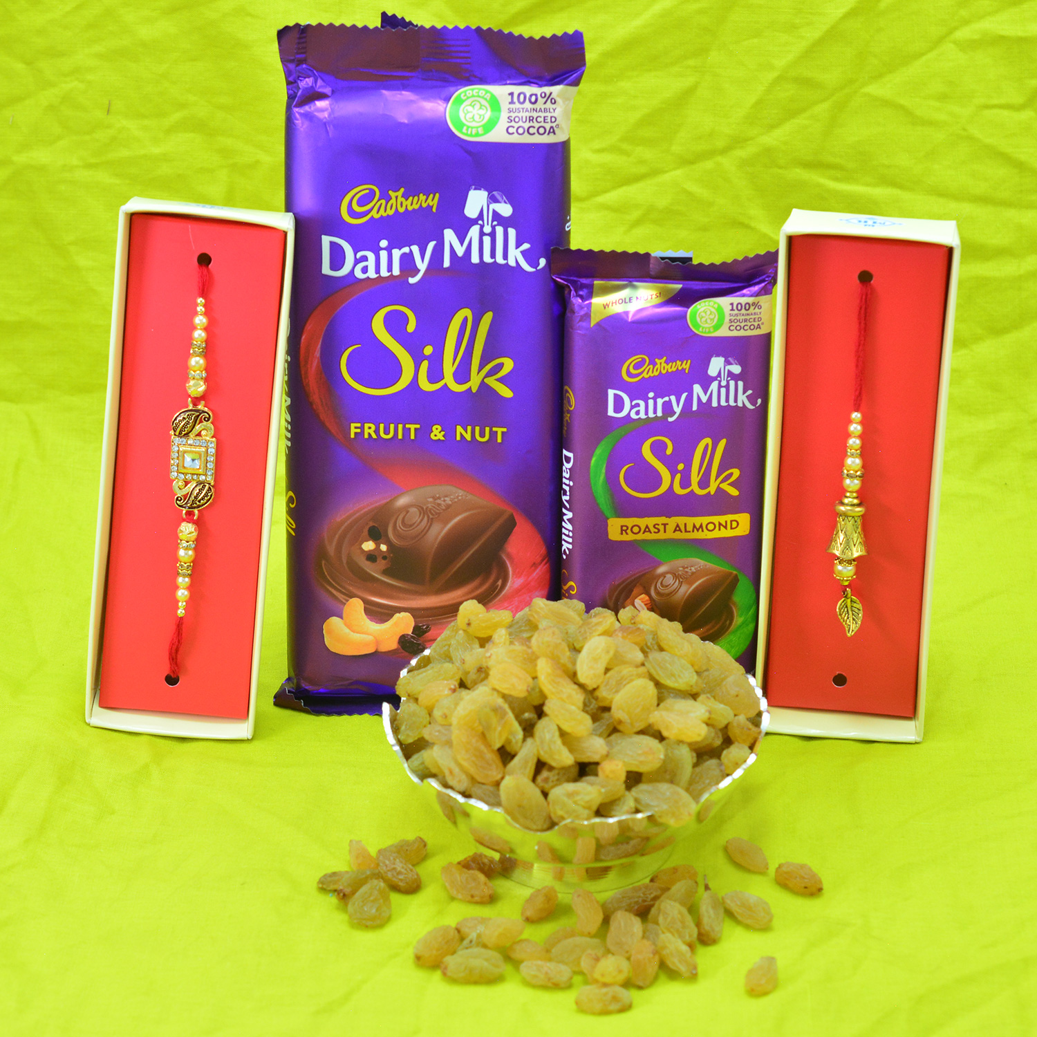 Dairy Milk Silk Chocolates with Golden Pair of Bhaiya Bhabhi Rakhis and Kishmish Dry Fruit