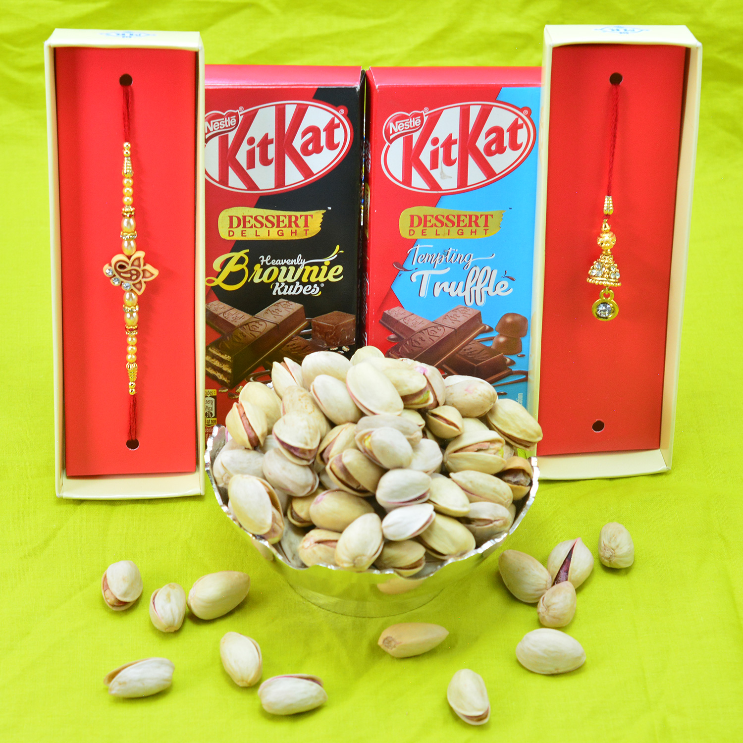 Brother and Bhabhi Rakhi with Tasty Branded Kitkat Chocolates and Pista Dry Fruit Hamper
