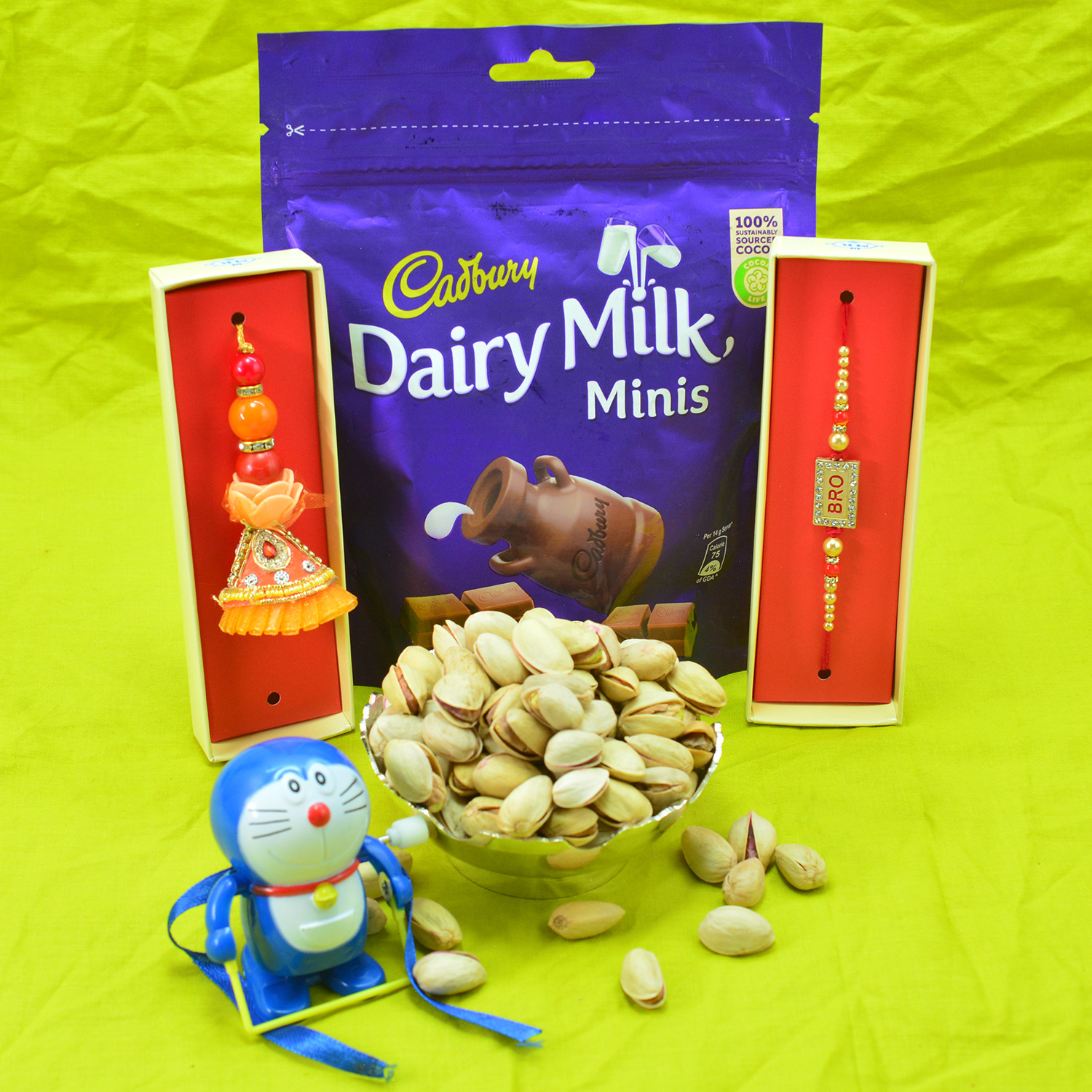 Cadbury Dairy Milk Chocolates Pack with Family Rakhi Set and Pista Dry Fruits
