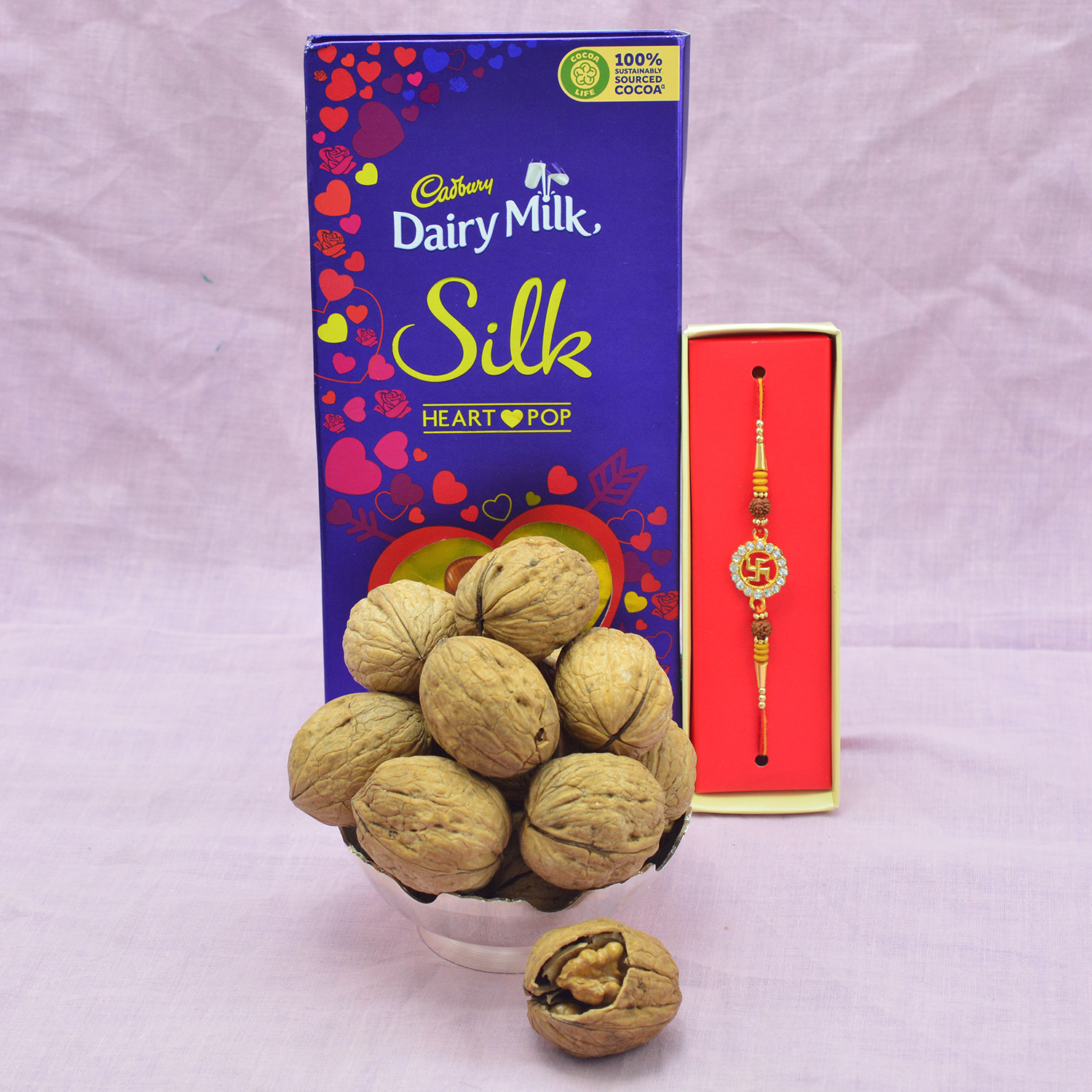 Heart Pop Silk Cadbury Chocolate with Sacred Brother Rakhi and With shells Walnuts 