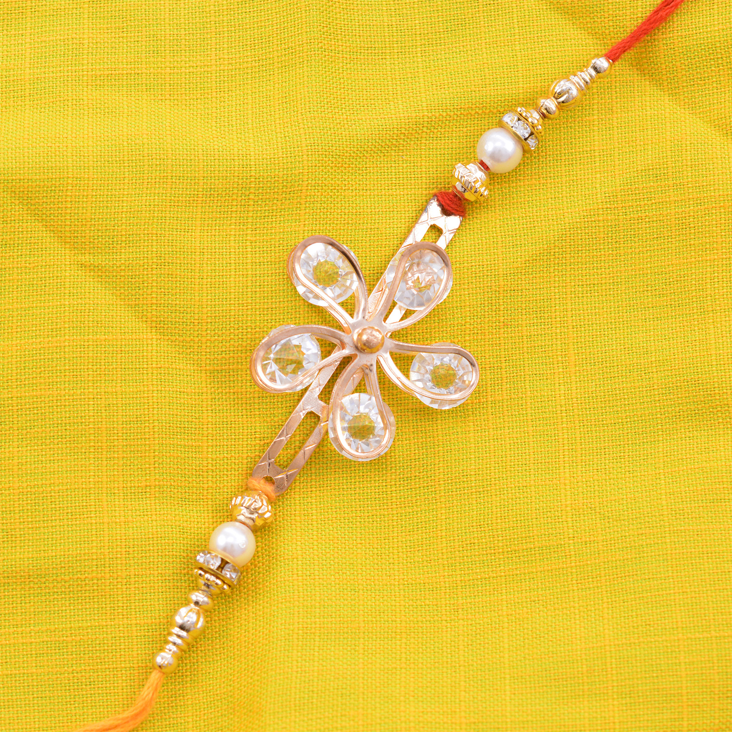 Golden Colored Floral Shape Diamond Designer Rakhi