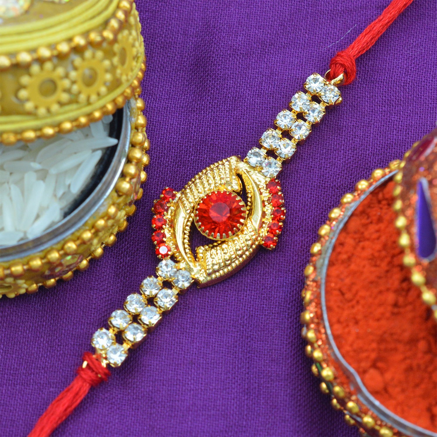 Awesome Red Diamond Studded in Deep Golden Eye Design with Jewel in Silk Thread