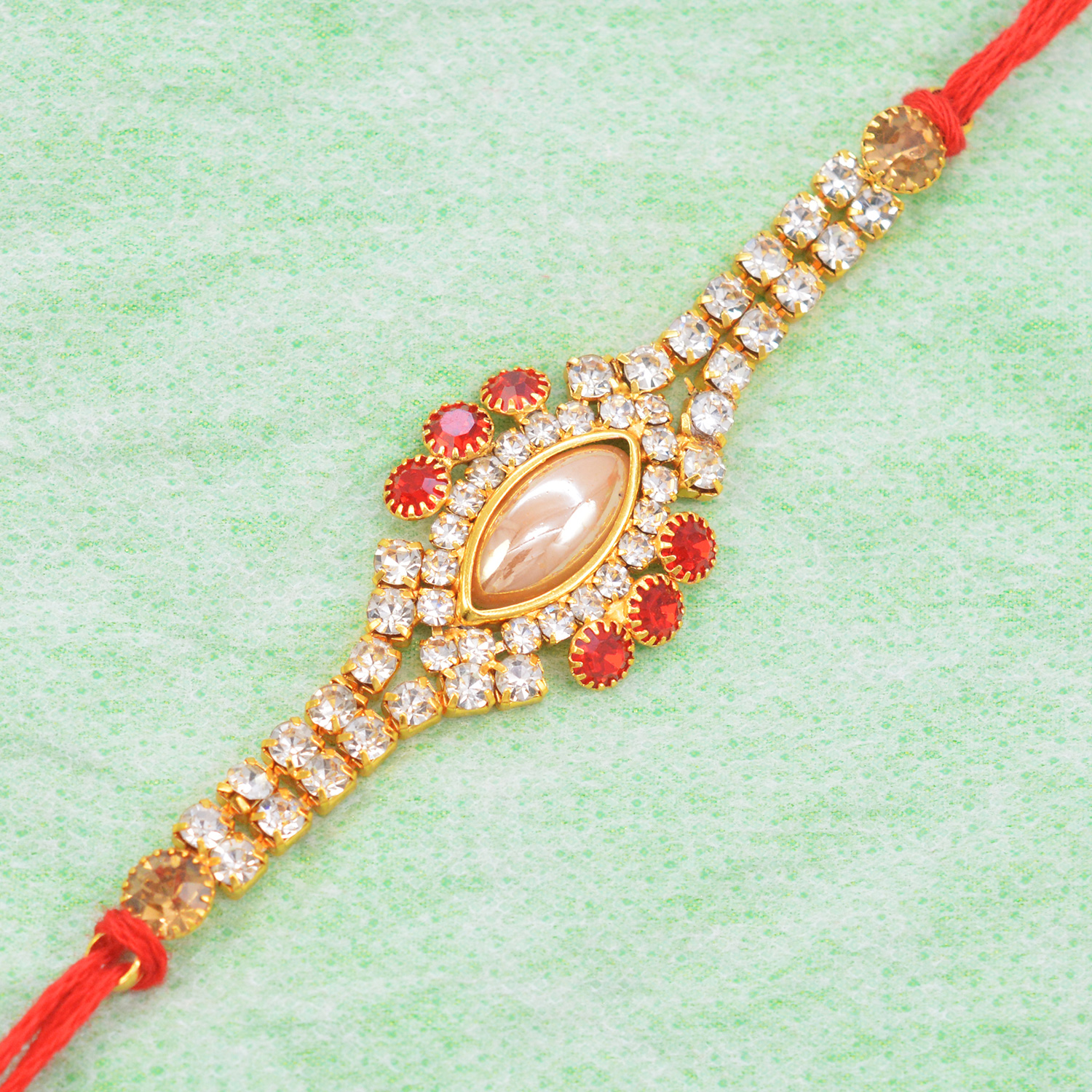 Gorgeous Golden Pearl Eye Decorated with Graceful Tiny Diamonds in Amazing Red Silk Thread