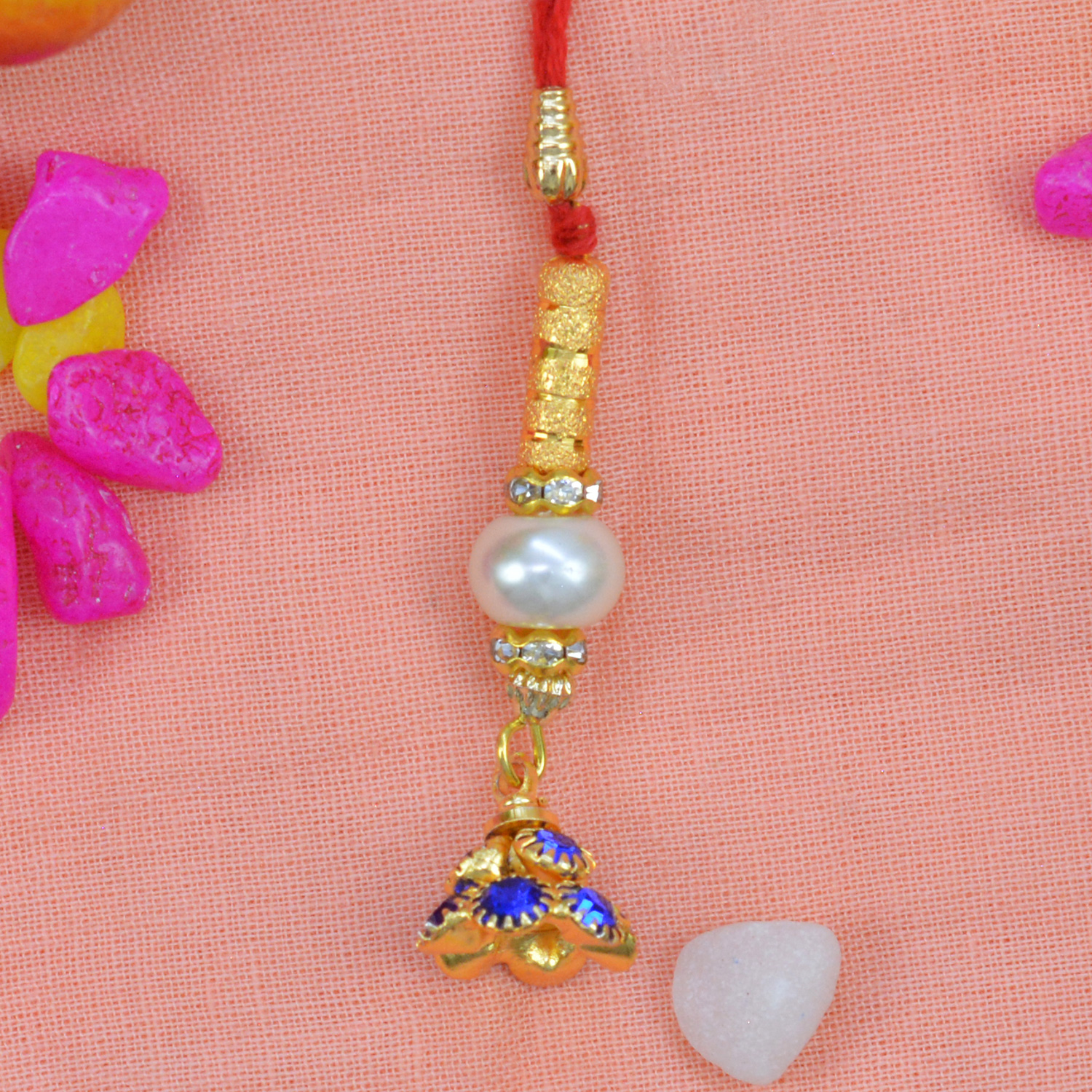 Blue Color Beautiful Jewels on Golden Colored Jhumka Lumba Rakhi
