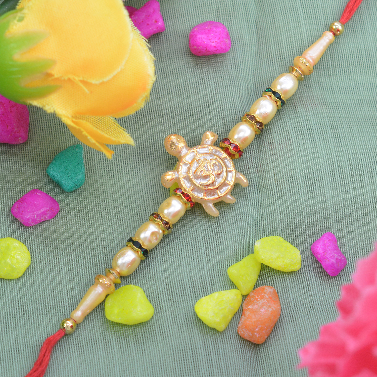 Beautiful Turtle on Golden OM Pearl Rakhi with Graceful Silk Thread