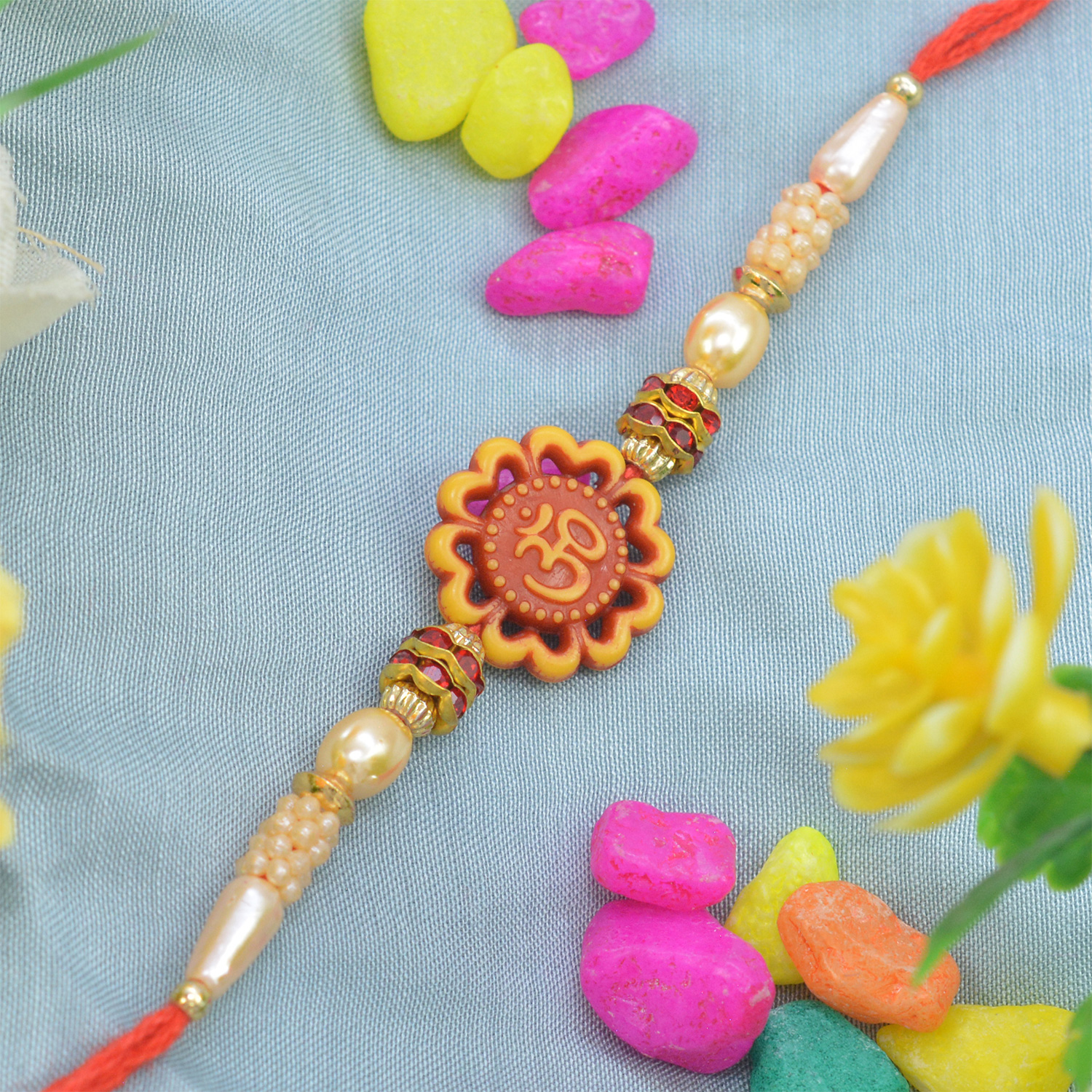 Gorgeous OM Flower Design with Shining Golden Pearls in Silk Dori