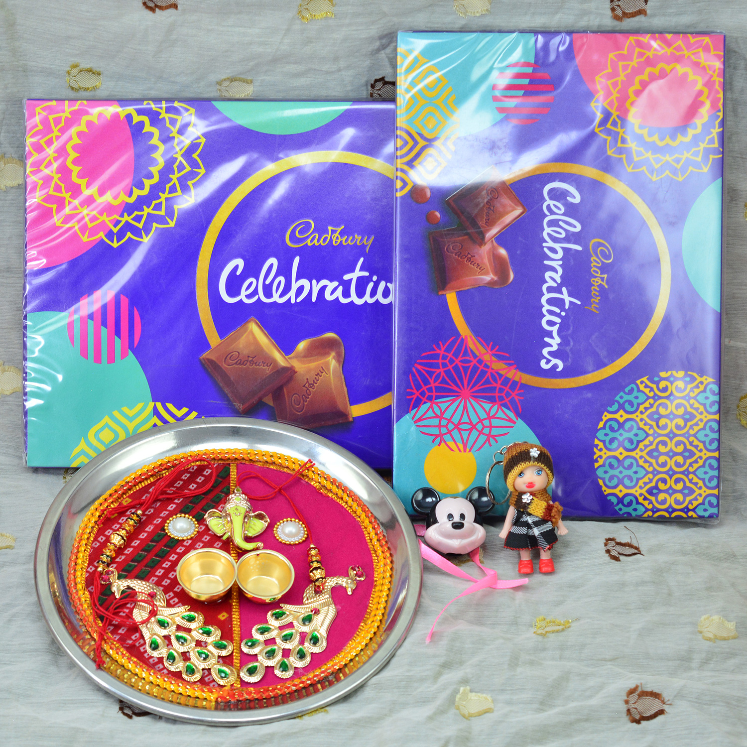 Cadbury Small and Big Celebration Pack of Chocolates with Peacock and Ganesha Auspicious Rakhi Puja Thali