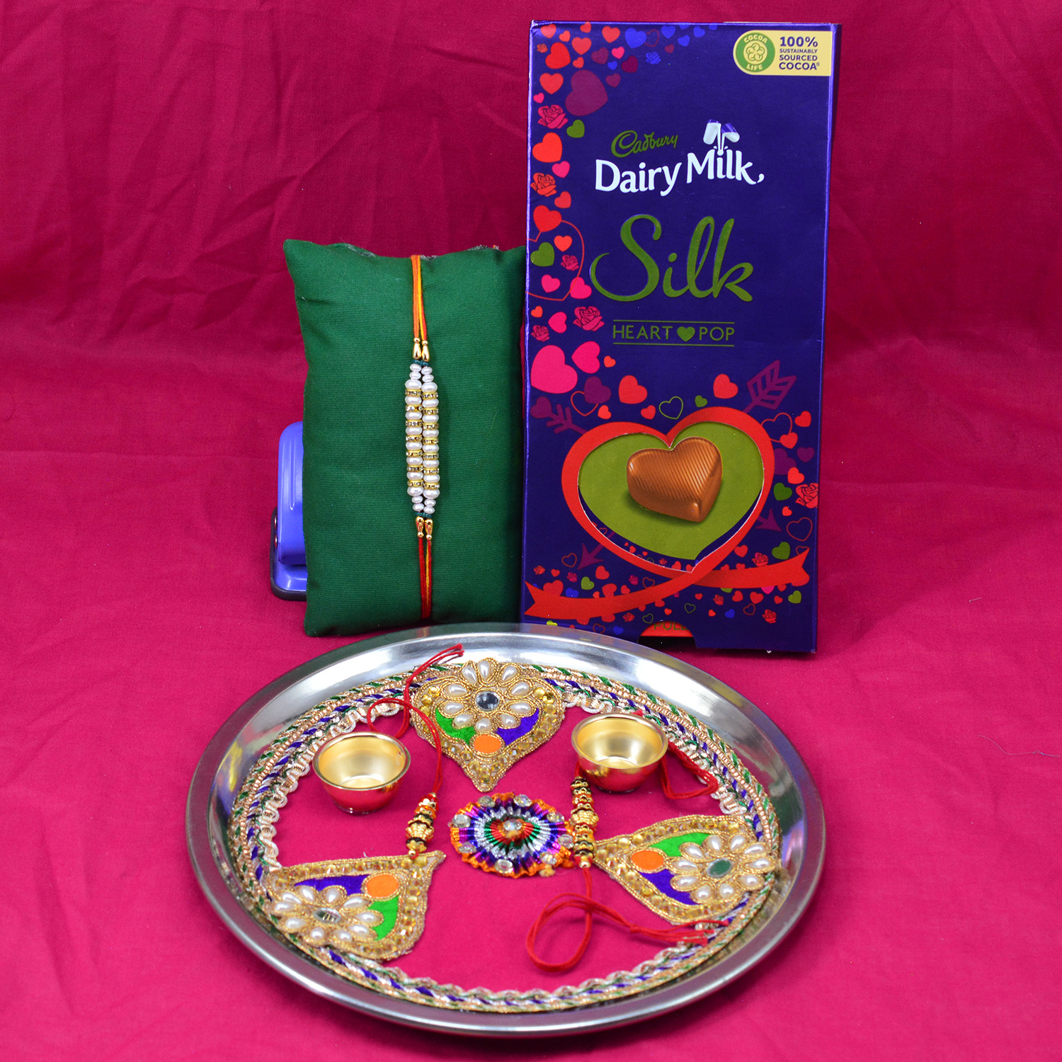 Dairy Milk Silk Heart Pop Chocolate with Beaded Thread Rakhi and Pan Shape Design Pink Base Puja Thali