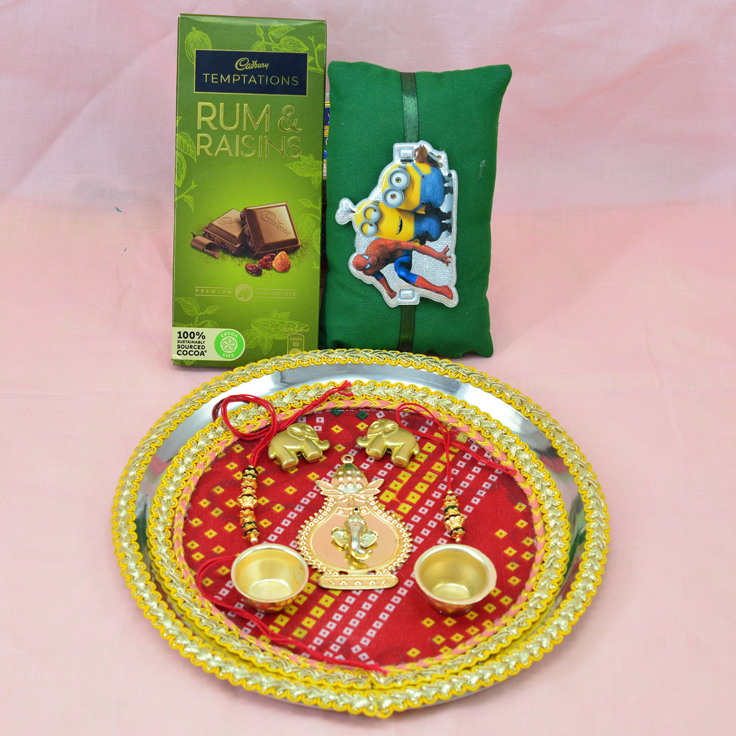 Divine Ganesha and Elephants Studded Rakhi Pooja Thali with Cadbury Temptation Rum and Raisins Chocolate