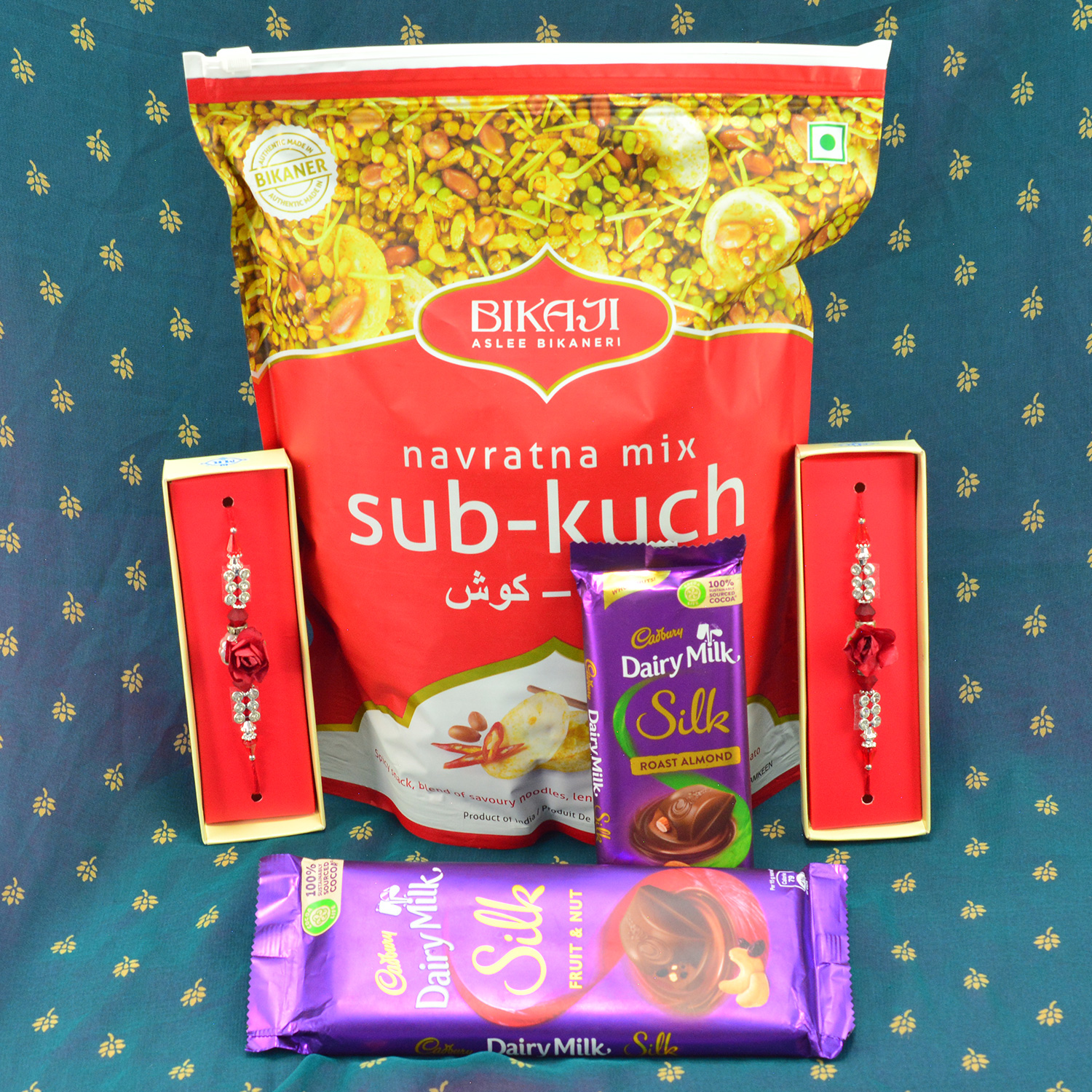 Wonderful Flower Shape Rakhi with delicious Cabury Dairy Milk Silk Chocolates and acrid Bikaji Navrtna Mix Sab Kuch