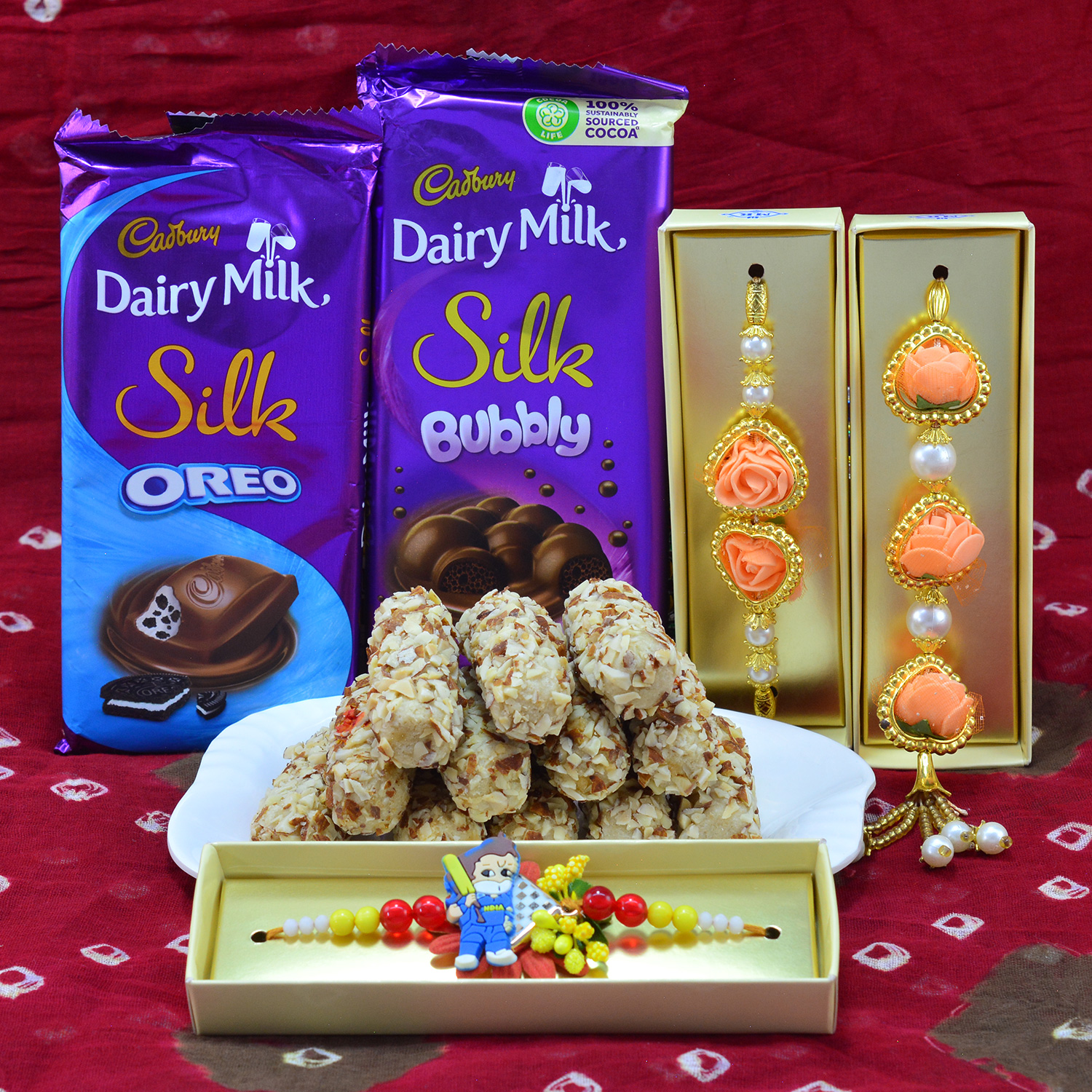 Flavorsome Kaju Butterscotch Roll with Two Luscious Dairy Milk Silk Oreo and Bubbly with Attractive Flower Shape Rakhi with Kids Cartoon Rakhi