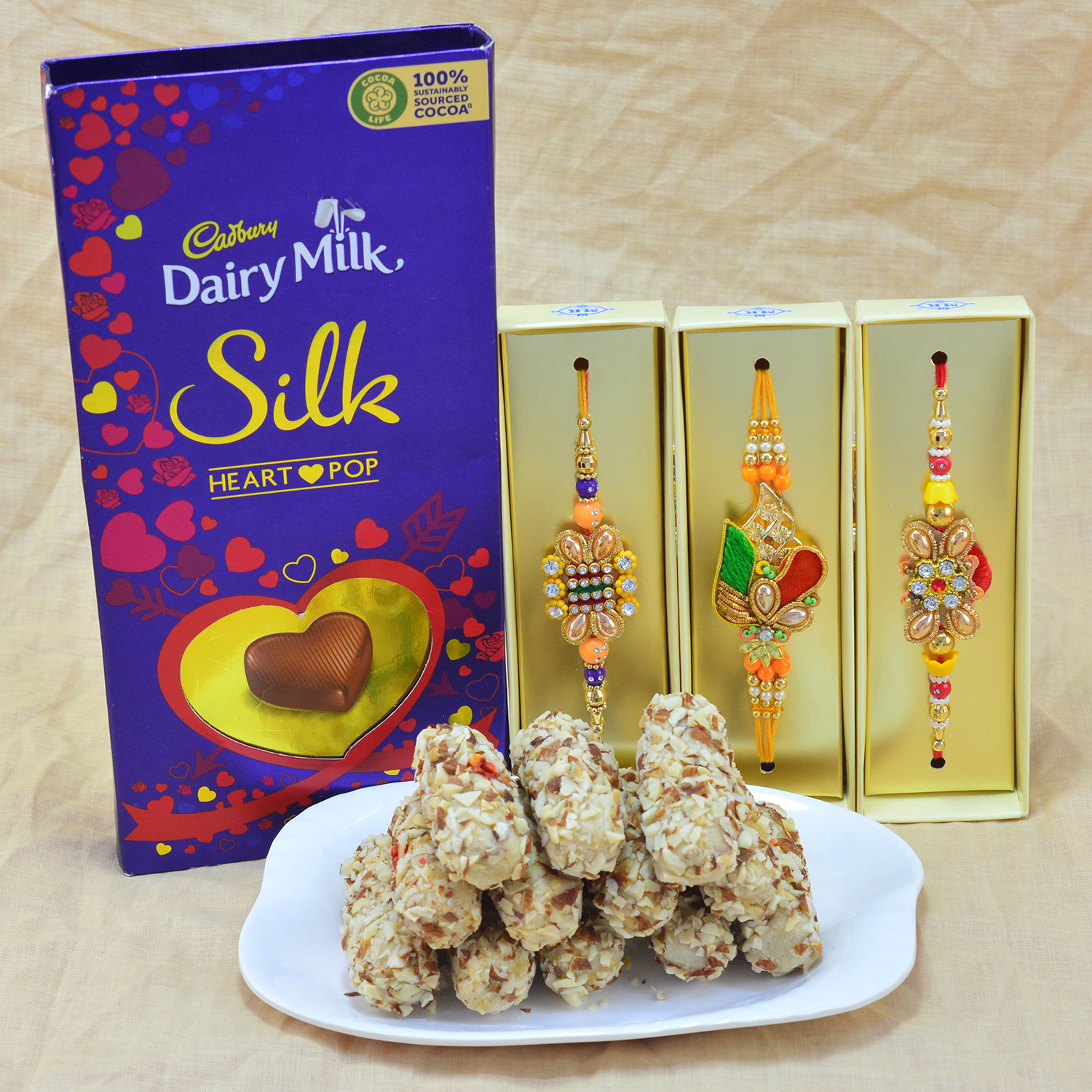 Scrumptious Diamond Jewel Zardosi Rakhi with Luscious Kaju Butterscotch Roll with Yummy Cadbury Dairy Milk Silk 
