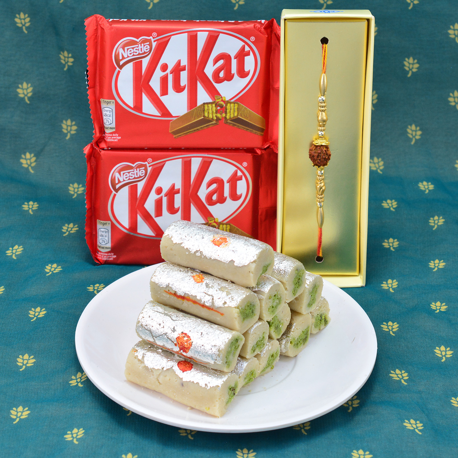 Magnificent Rudraksha Rakhi with Delicious Nestle Kitkat with entrancing Kaju Roll Hamper