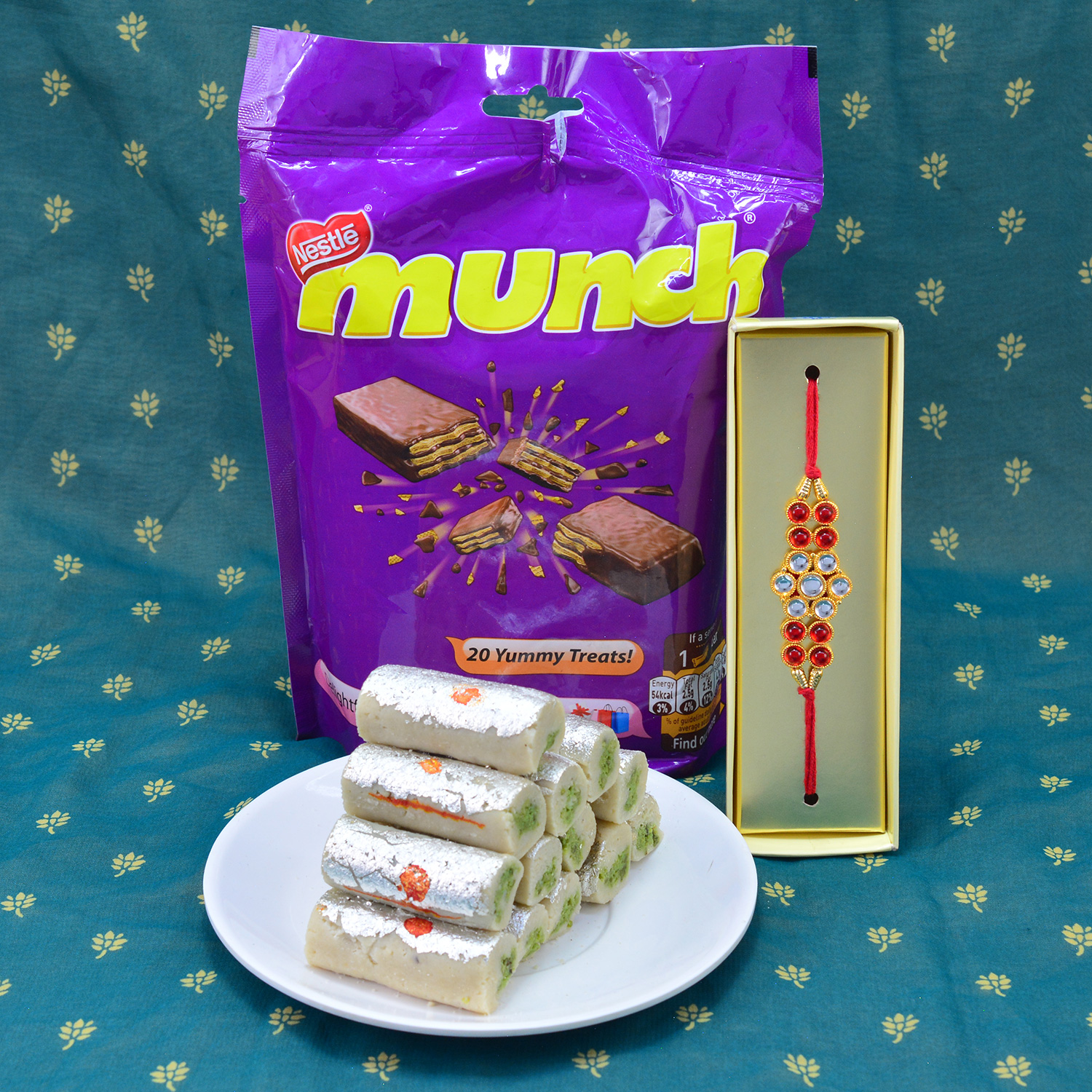 Gorgeous Red n White Diamonds Jewel Rakhi with Delicious Nestle Munch with Captivating Kaju Roll