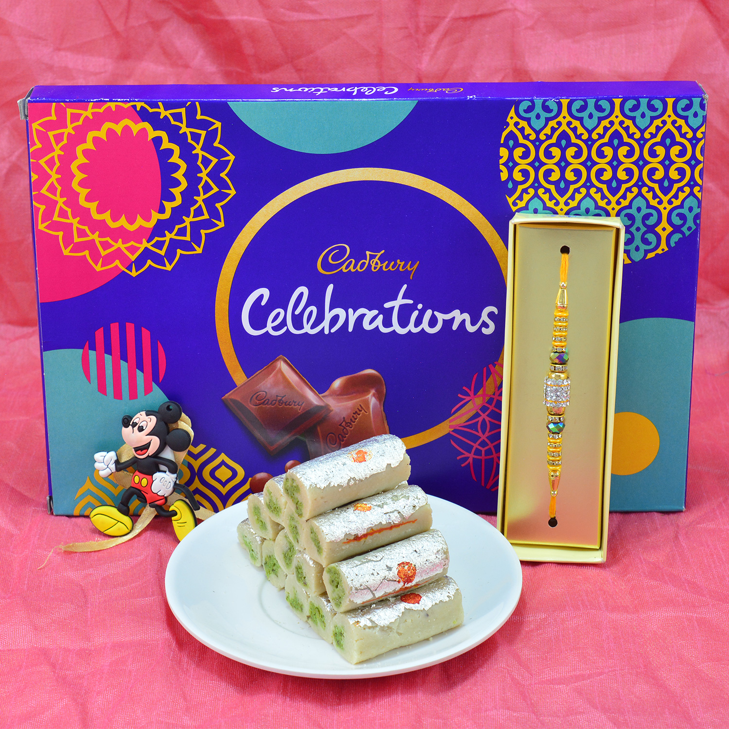 Amazing Jewel beads Rakhi with Mickey Mouse Rakhi and Delicious Cadbury Celebrations with Tasty Kaju Roll