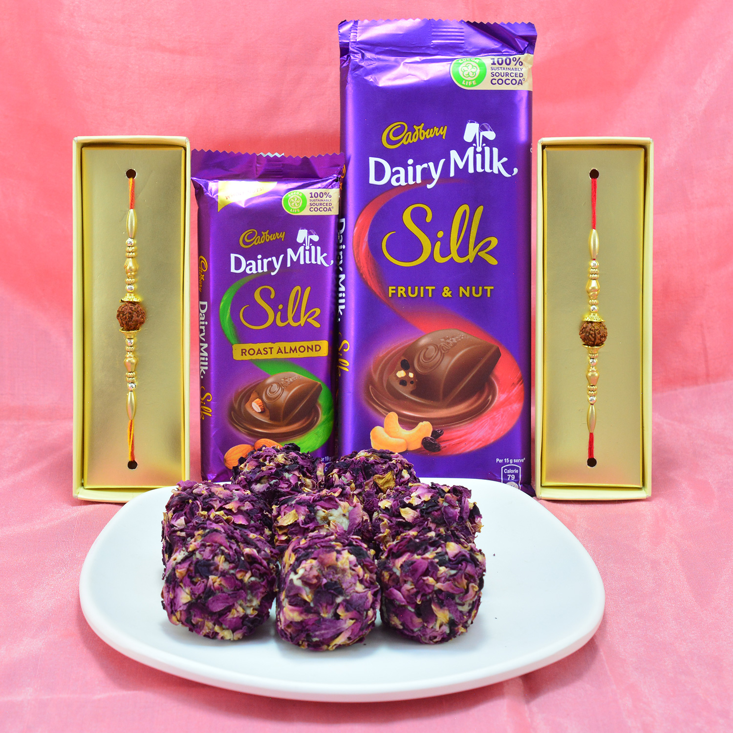 Delightful Cadbury Dairy Milk Silk with delicious Kaju Rose Laddu along with Magnificent Rudraksha Rakhi