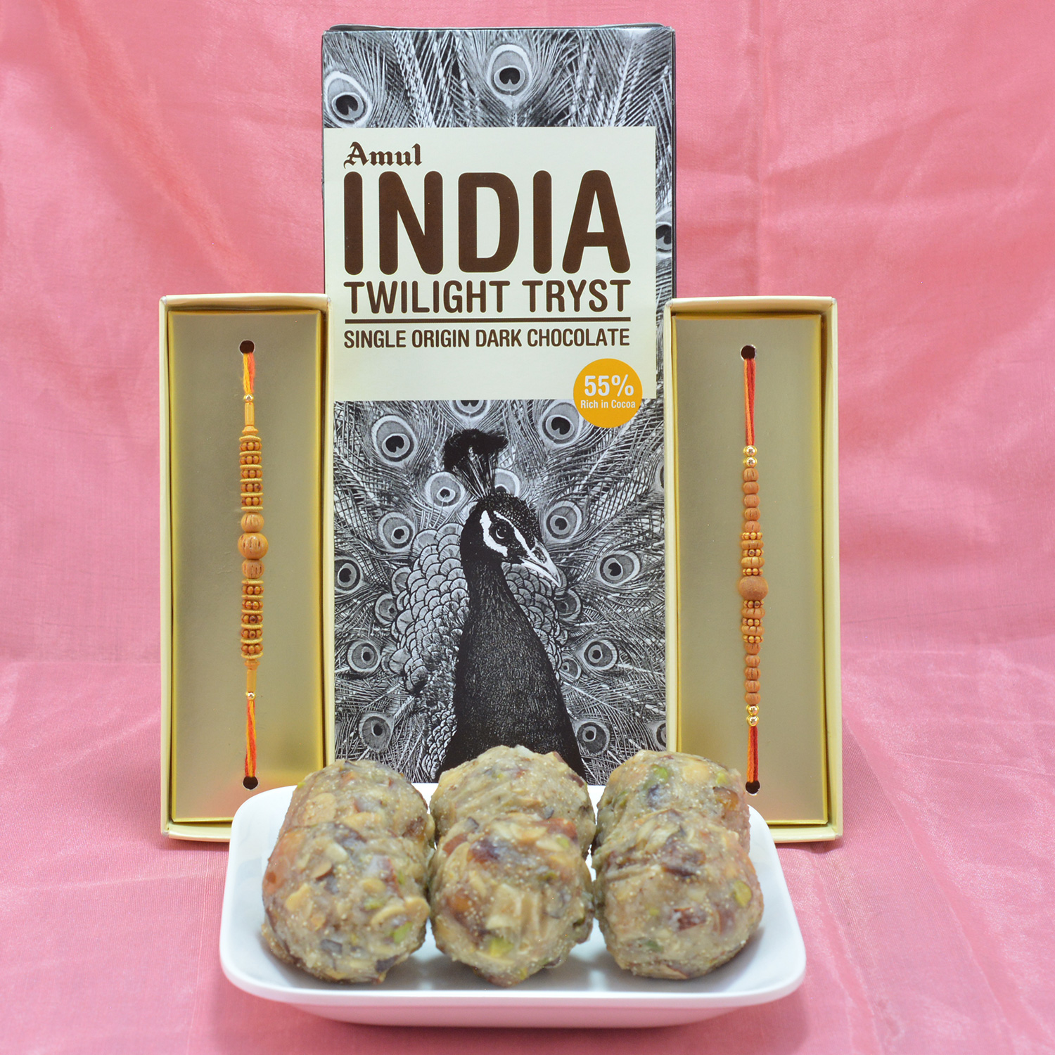 Wonderful Sandalwood Beads Rakhi with Delicious Amul India Chocolate along with luscious Mix Dry Fruit Laddu
