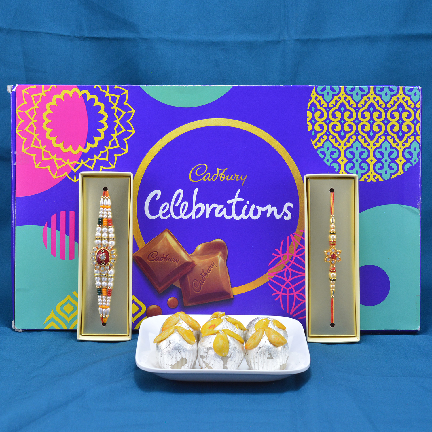 Piquant Kaju Badam Laddu with Luscious Cadbury Celebrations along with Multicolor Diamond Jewel Rakhi Hamper