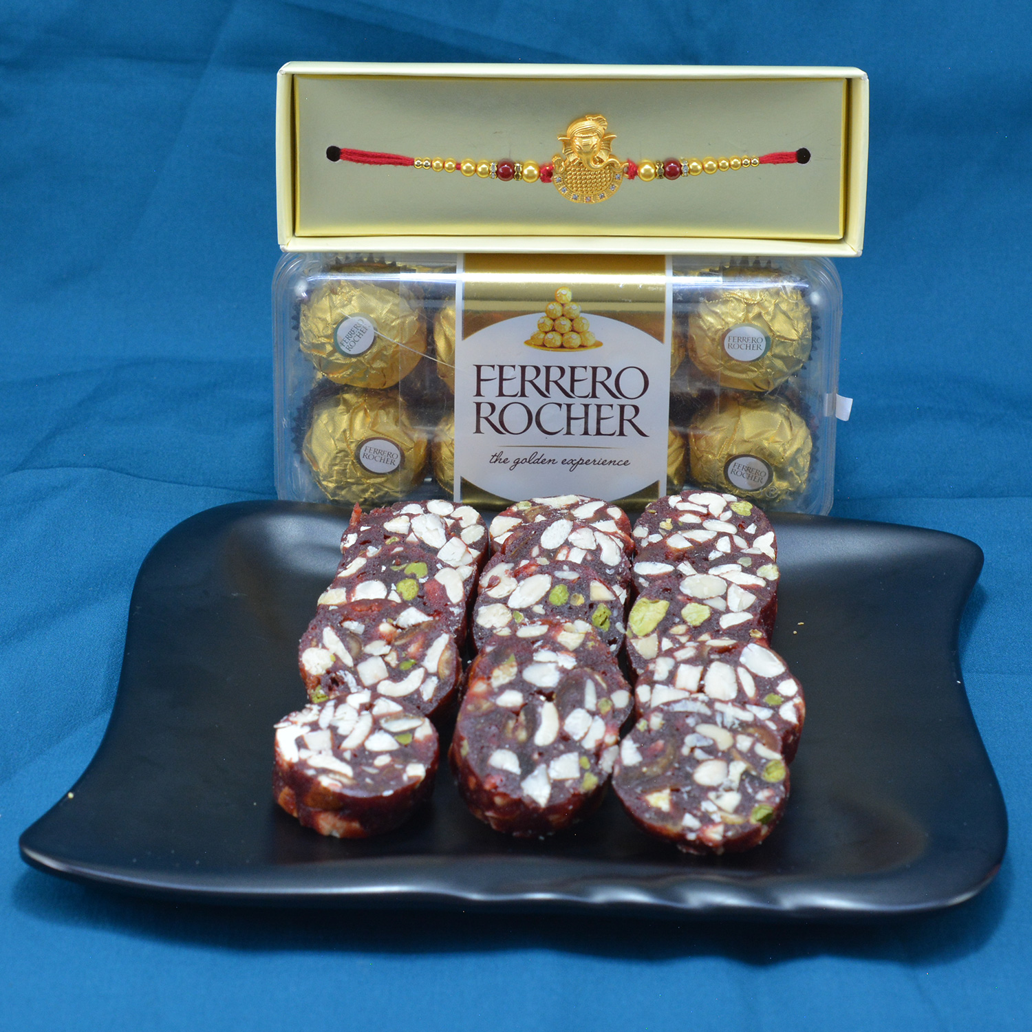 Piquant Kaju Anjeer Dry Fruits with Luscious Ferrero Rocher along with Magnificent Golden Theme Rakhi Hamper