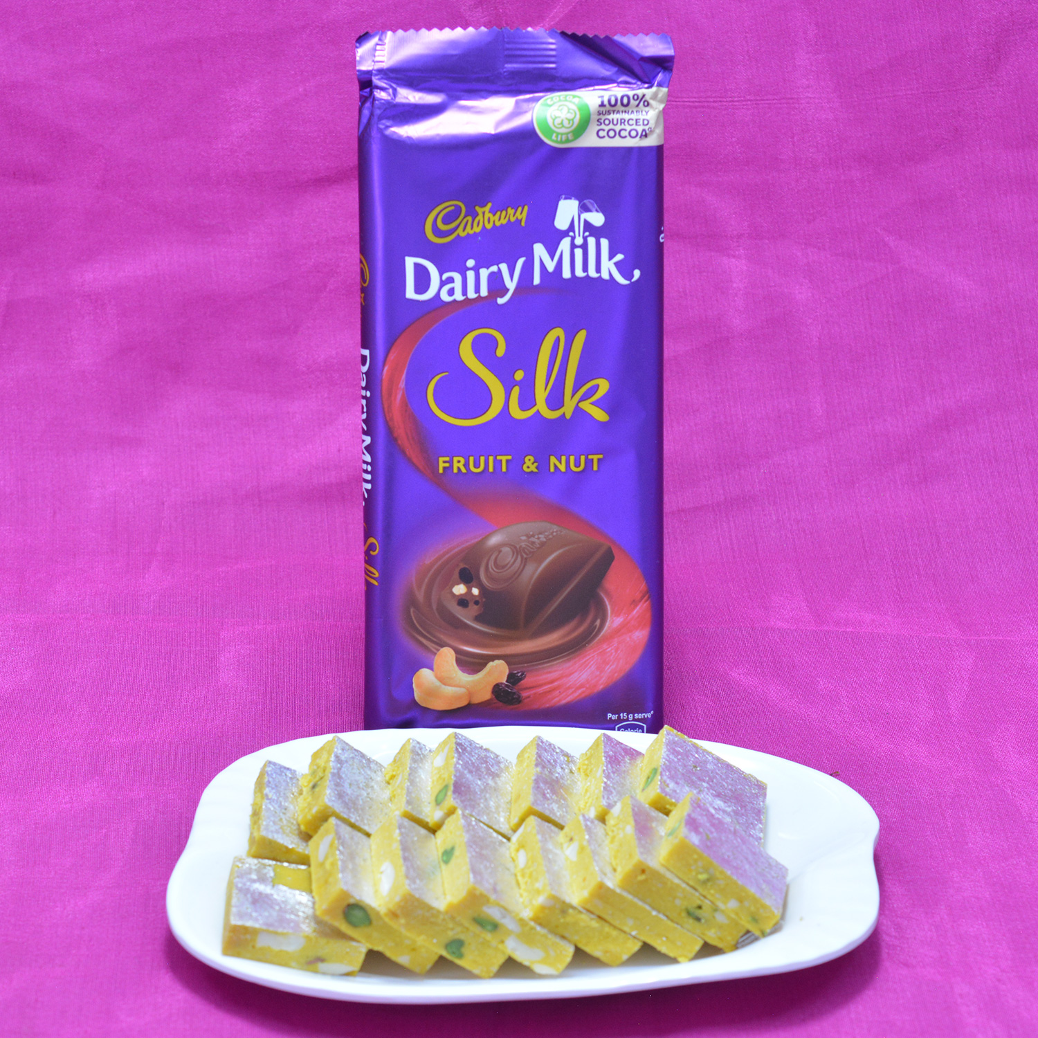 Mouthwatering Kaju Kesar Pista Barfi with Finger Licking Cadbury Dairy Milk Silk Chocolate Hamper