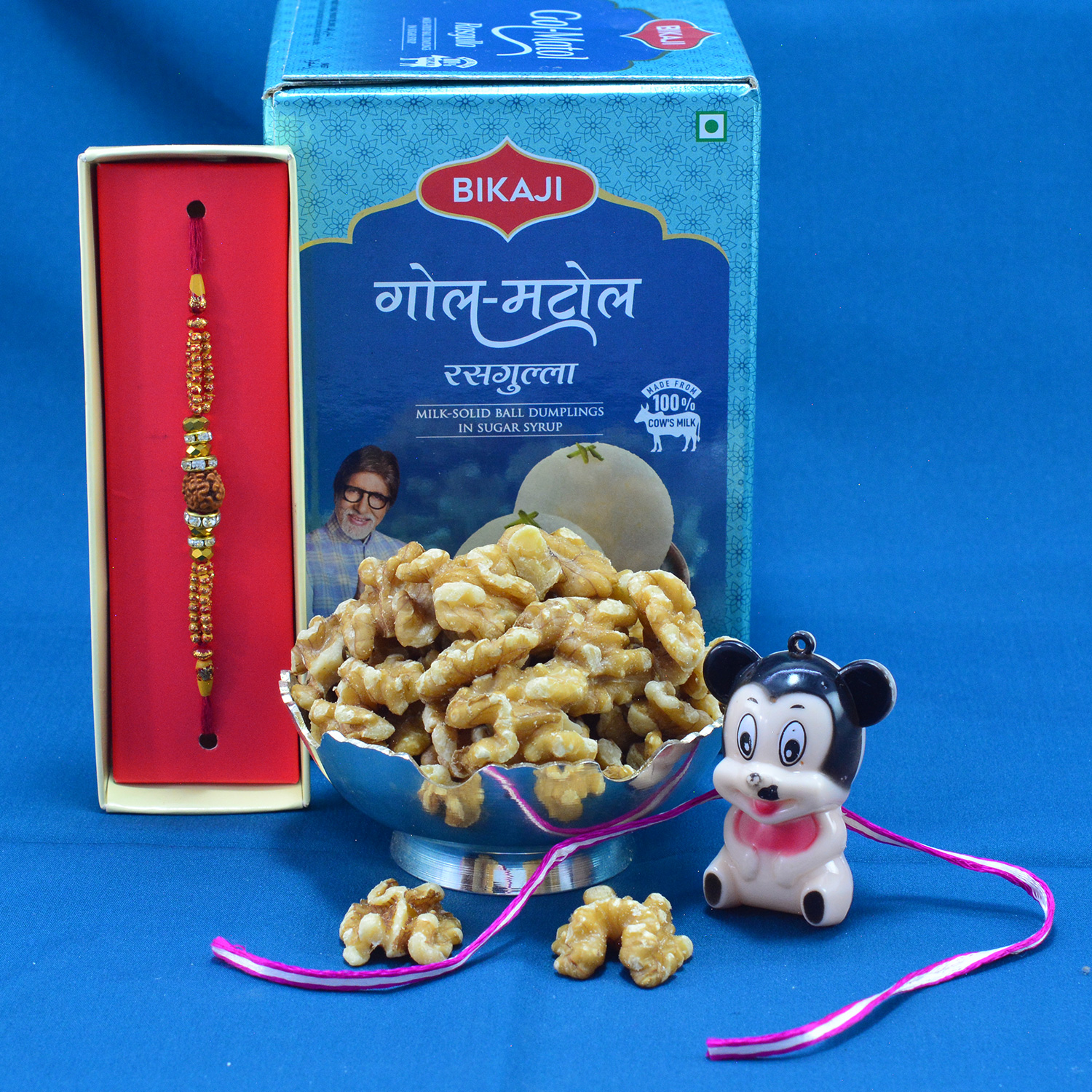 Stunning Rudraksha Beads Rakhi with Kids Rakhi along with Tasty Walnuts and captivating Bikaji Gol Matol Rasgulla