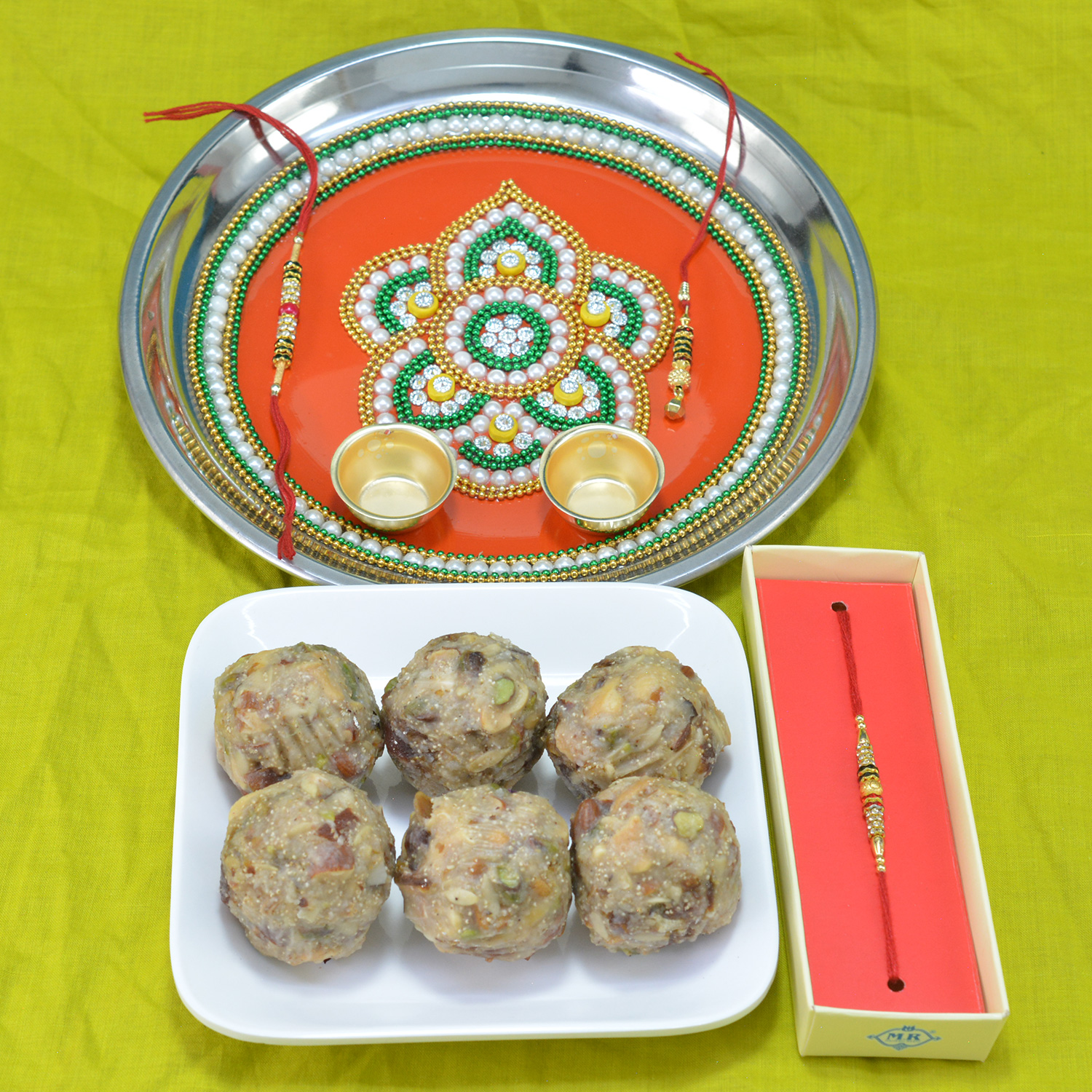 Piquant Kaju Dry Fruit Laddu with Colorfully Designed Pooja Thali along with Brother Rakhi