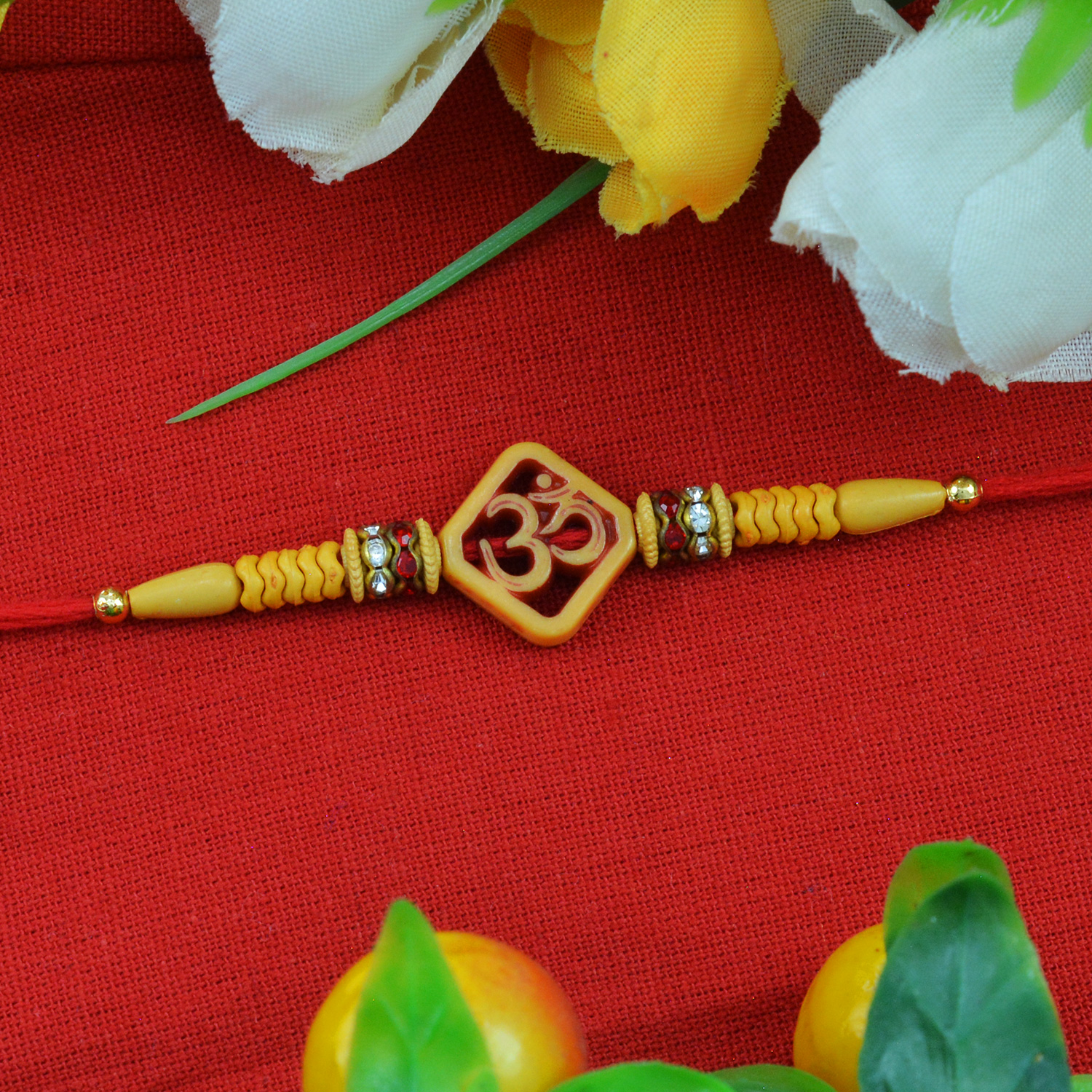 Beautiful Square Shape Wooden Studded OM Sandalwood Rakhi with Attractive Golden Beads