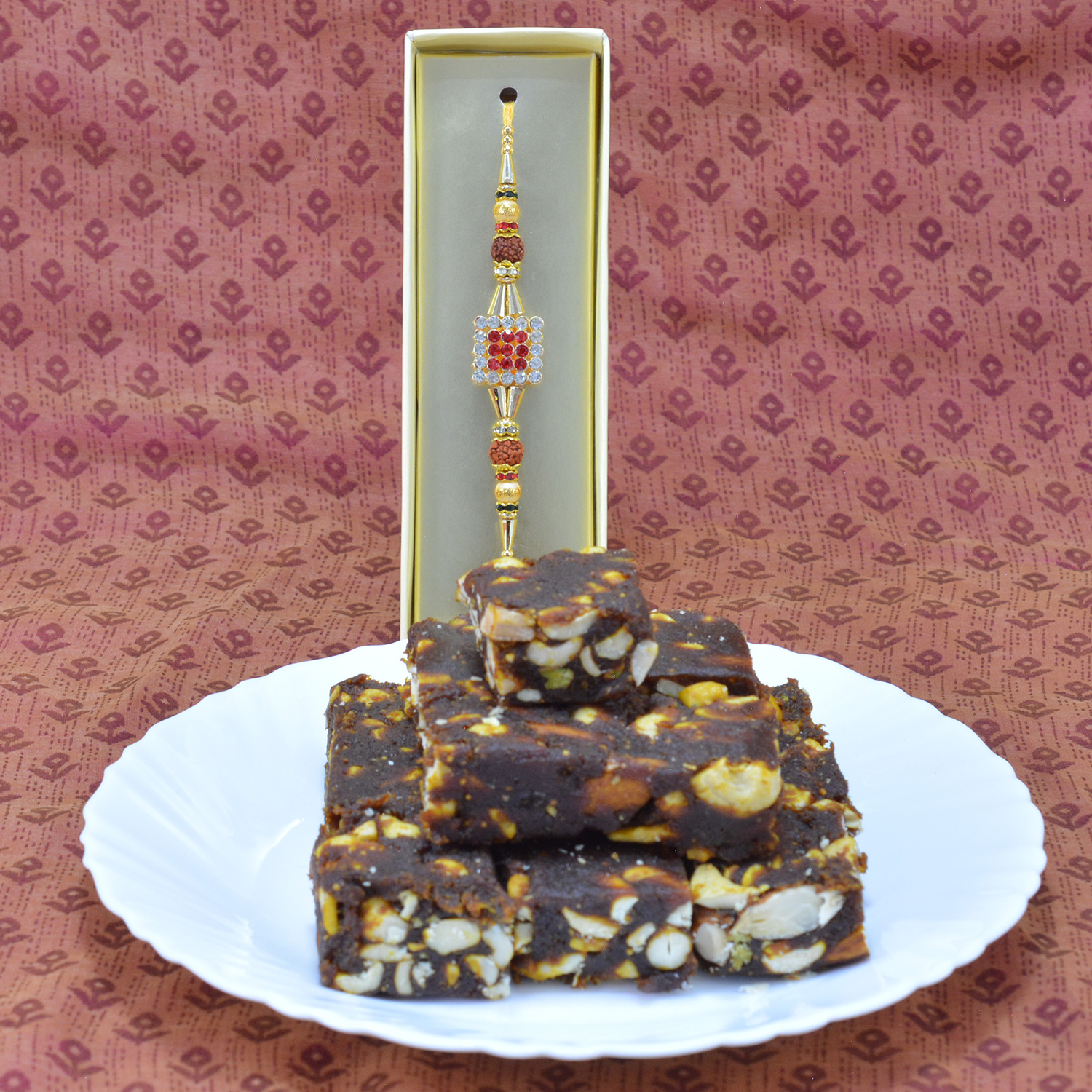 Square Shape Jewel Studded Brother Rakhi with Sweet of Anjeer Dry fruit Branded Barfi