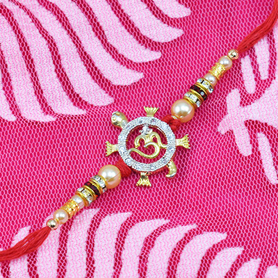 Divine Om Tortoise Rakhi with pearls in mauli dori