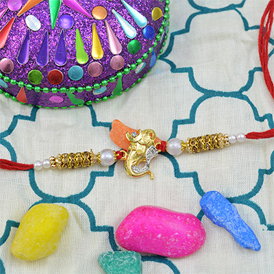 Golden Ganesha rakhi with pearls and diamonds