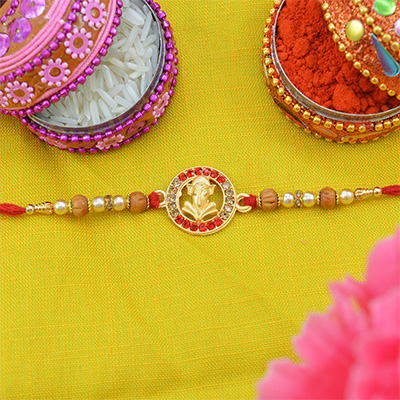 Round Shape Lord Ganesh Rakhi with Sandalwood Beads and Pearls