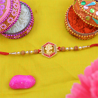 Golden Ganesha Rakhi with red Diamonds and Pearls