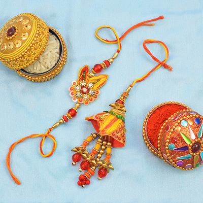 Orange and Red Colored Antique Design Bhaiya and Bhabhi Set of Rakhis