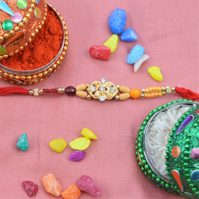 Golden Color Rakhi With Sandalwood Beads 