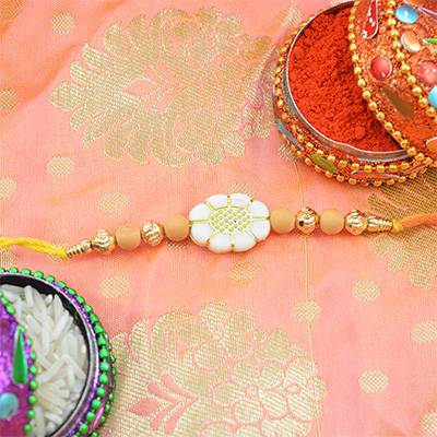 Sandalwood and Golden Beads White Color Floral Rakhi