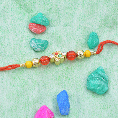 Remarkable Golden and Red Beads Rakhi