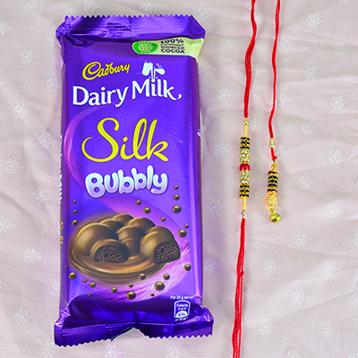 Golden Bhaiya Bhabhi Rakhi Set with Delicious Cadbury Dairy Milk Silk Bubbly Chocolate
