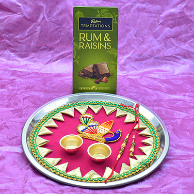 Cadbury Temptation Rum Raisins and Pink Colored Rakhi Pooja Peacock Thali