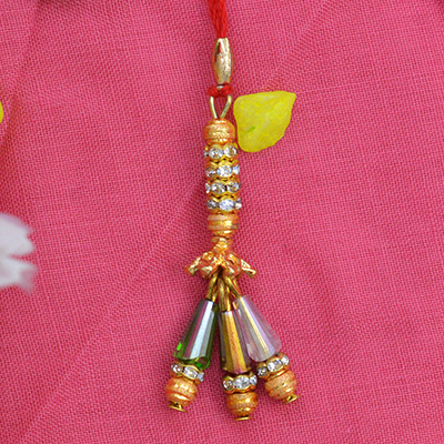 Three handing Different Shaped Beads On a Golden Lumba Rakhi for Bhabhi