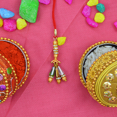 Three handing Different Shaped Beads On a Golden Lumba Rakhi for Bhabhi