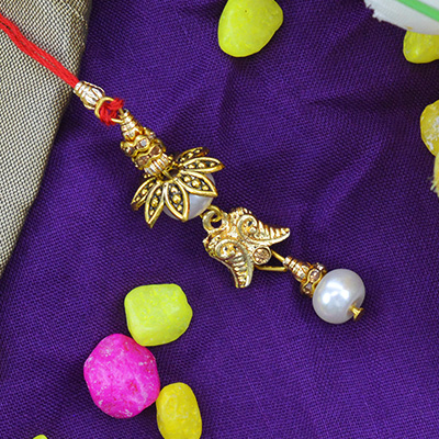 Beads and Flower Leafs Hanging on a Red Threaded Lumba Rakhi