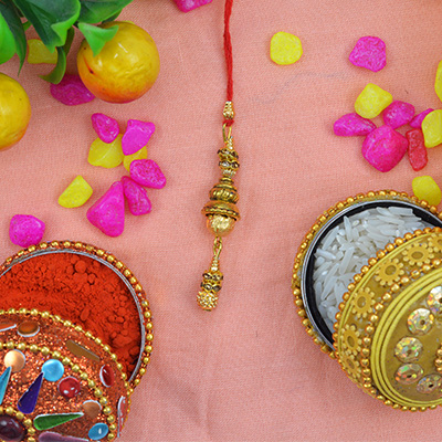 Golden Beads Hanging on Red Threaded Designer Lumba Rakhi for Bhabhi