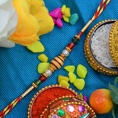Marvelous Oval Multi-color Design Shape Moli Rakhi with Amazing Pearls and Graceful Silk Thread