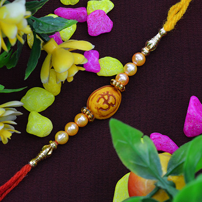 Fascinating OM on Oval Shape Moli Rakhi with Rich look Pearls 