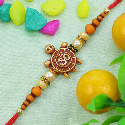 Gorgeous Turtle on Golden OM Moli-Dori Rakhi with Awesome Pearls Silk Thread