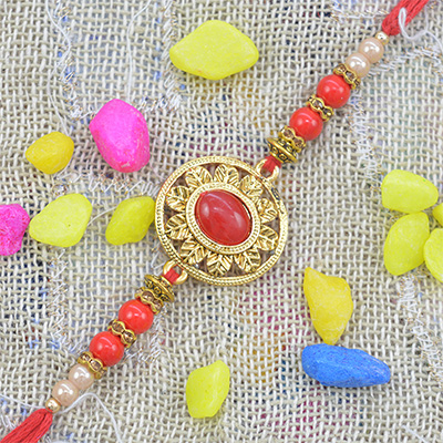 Amazing Golden Round Shape Studded in Red Precious Beads Pearl Rakhi with Silky Thread