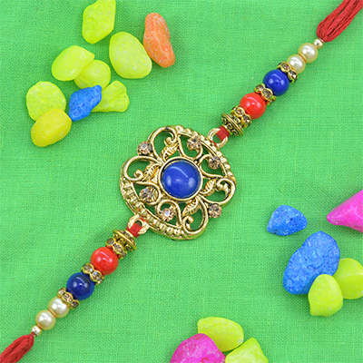 Beautiful Navy Blue Studded in Deep Golden Shape Pearl Rakhi with Red Silk Thread