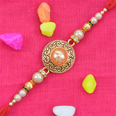 Marvelous Golden Beads Studded in Rounded Rakhi with Shining White Pearls